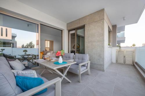 a living room with a couch and a table at Mulberry Court Premium Apartments in Limassol