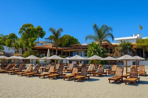 a row of chairs and umbrellas on a beach at Mulberry Court Premium Apartments in Limassol