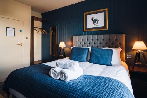 a bed with three rolled towels on top of it at Richard III Hotel in Middleham