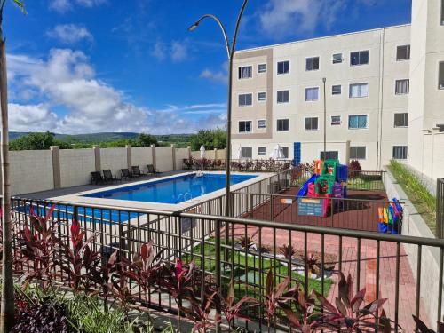 a swimming pool in front of a building at Cantinho das bromélias in Caruaru