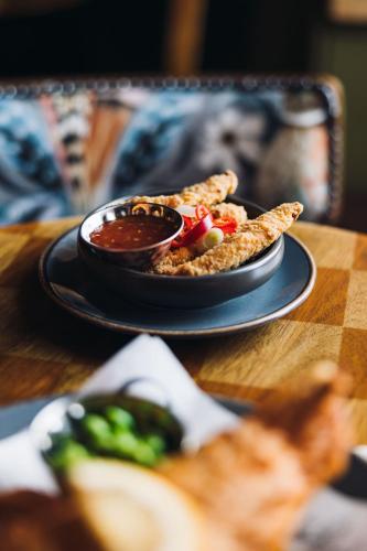 a plate of food on a table with a plate of food at Richard III Hotel in Middleham