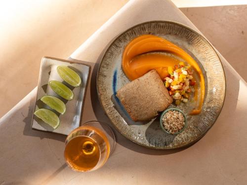 a plate of food with bread and vegetables and a drink at Hurricane Jeri in Jericoacoara