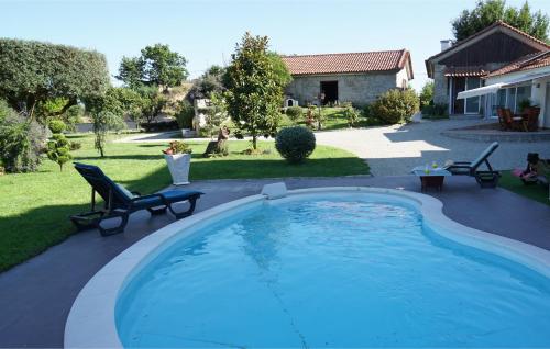 a swimming pool in the backyard of a house at Le refuge in Tondela