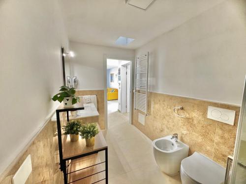 a bathroom with a sink and a toilet at Pozzelle Holiday House in Zollino