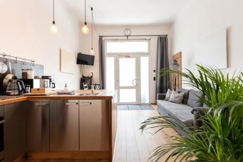 a kitchen and a living room with a couch at Zentrales & modernes City-Apartment in Graz