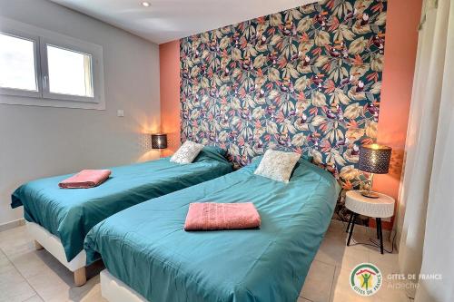 - 2 lits jumeaux dans une chambre avec papier peint dans l'établissement Villas Nature et liens, à Saint Alban Auriolles