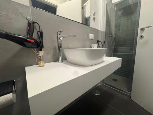a bathroom with a white sink and a shower at The Better in San Giorgio a Cremano