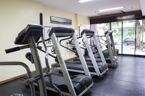 a gym with several tread machines in a room at Scorial Rio Hotel in Rio de Janeiro
