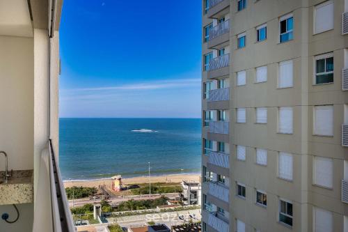 a view of the ocean from a building at Condomínio a beira-mar c/ piscina - SHC in Piçarras