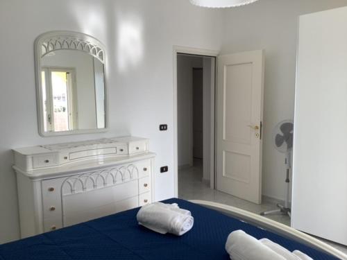 a bathroom with a bed and a mirror and a tub at BenitiKe House in Cala Gonone