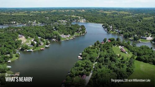 an aerial view of a lake with houses and trees at The Lodges at Eden Reserve - Cabin Loop - Near Ark in Williamstown