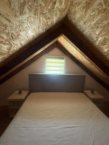 a bedroom with a bed and a window at Mila in Danilovgrad