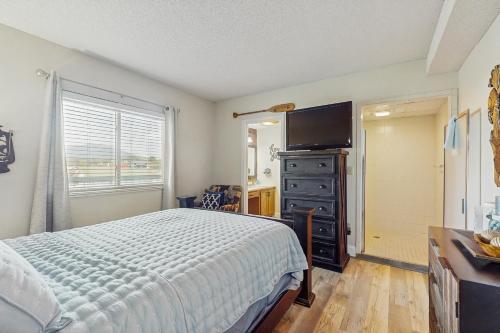 a bedroom with a bed and a flat screen tv at Rivers Edge Condo 407 in Pigeon Forge