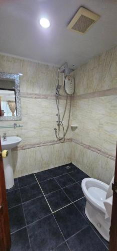 a bathroom with a shower and a toilet and a sink at Hello Jomtien in Jomtien Beach