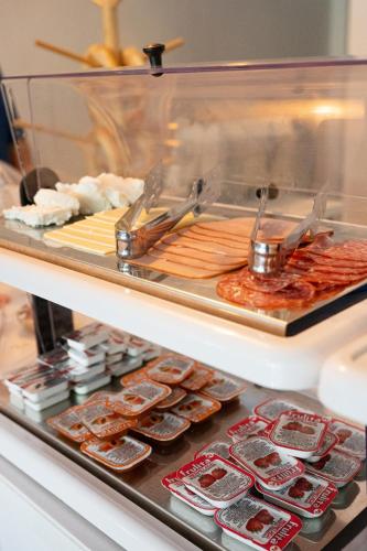a display case with many different types of food at The White Rose Hotel in Poros