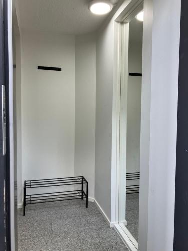 a hallway with a bench and a mirror at Studio with private entrance in Seinäjoki