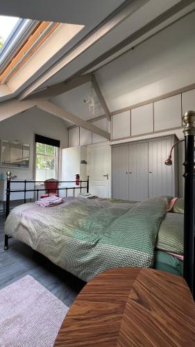 a bedroom with a large bed in a room at Vakantiehuis Toxopeus in Burgh Haamstede