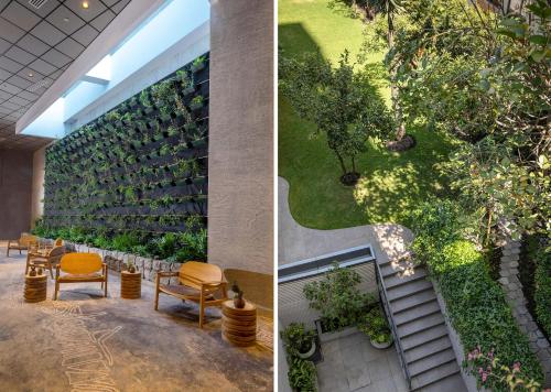 a wall of plants and chairs in a building at GO Quito Hotel in Quito