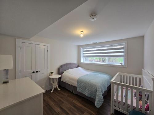 a small bedroom with a bed and a crib at Wheel chair Access, Private Boat Launch in Roseneath