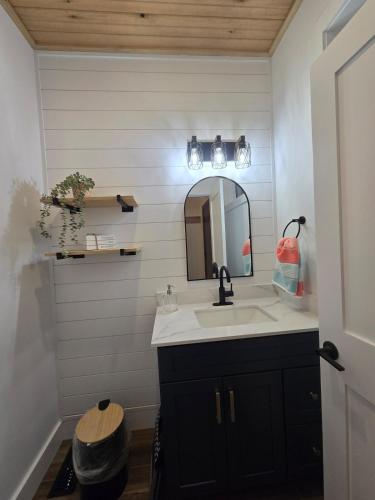 a bathroom with a sink and a mirror at Wheel chair Access, Private Boat Launch in Roseneath