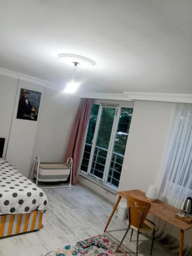 a bedroom with a bed and a desk and a table at Ahmet Teacher's villa is 6 minutes from Istanbul airport in Arnavutköy