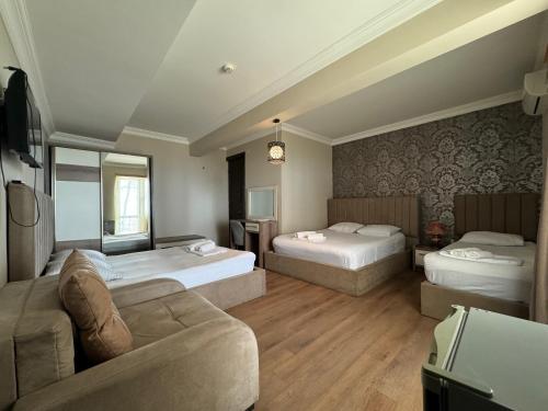 Postel nebo postele na pokoji v ubytování Karo Hotel