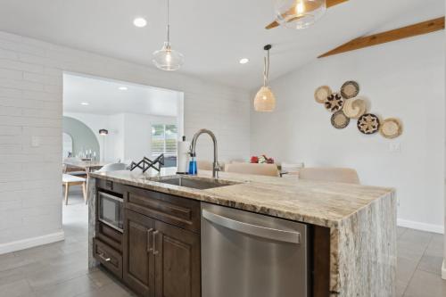 a kitchen with a sink and a counter at NEW Reins & Rivets by PaseoHomesAZ - Heated Pool in Tempe