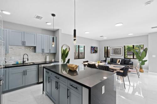 a kitchen and living room with a dining room at Spacious 4-BR House W Free Parking in Miami