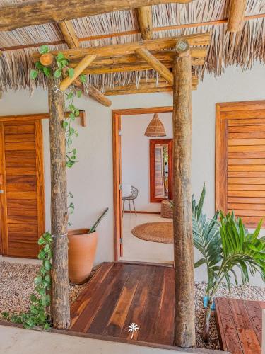 a living room with a wooden floor and a porch at La Villa Dune, um luxo com vista espetacular por mar e coqueiral ! Uma experiência unica ! in Icaraí