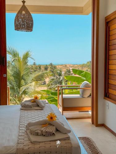 two beds in a room with a view of the ocean at La Villa Dune, um luxo com vista espetacular por mar e coqueiral ! Uma experiência unica ! in Icaraí