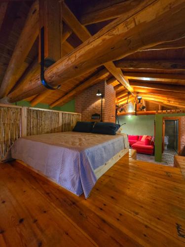 a bedroom with a bed in a room with wooden floors at Trifonas Loft in Ríva