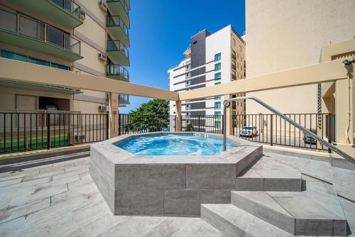a hot tub on a balcony of a building at Aston Waikiki Beach Tower 602 in Honolulu