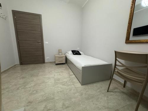 a bedroom with a bed and a chair in it at Paola HOME in Varazze