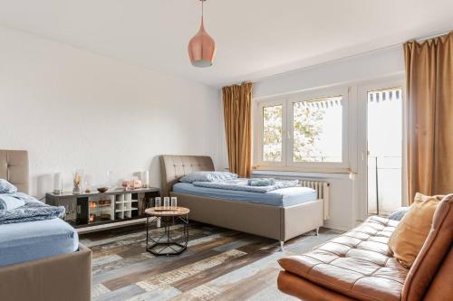 a living room with two beds and a couch at Zimmer mit Flair Köln-Messenähe in Cologne