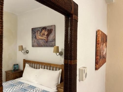 a bedroom with a bed and a painting on the wall at Tradiotional house in Metamorfosi