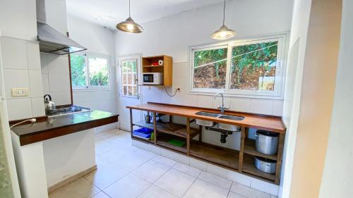 a kitchen with a sink and a counter top at Cabañas Mirasoles in Villa General Belgrano