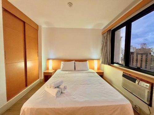 a hotel room with a bed with towels on it at LFlats Hotel Alameda Lorena Jardins in Sao Paulo