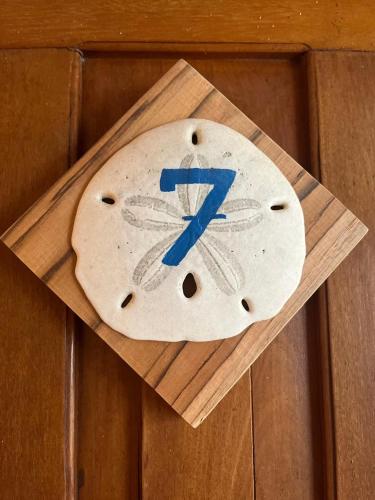 a clock on the side of a wooden wall at Casa del Sol in Montañita