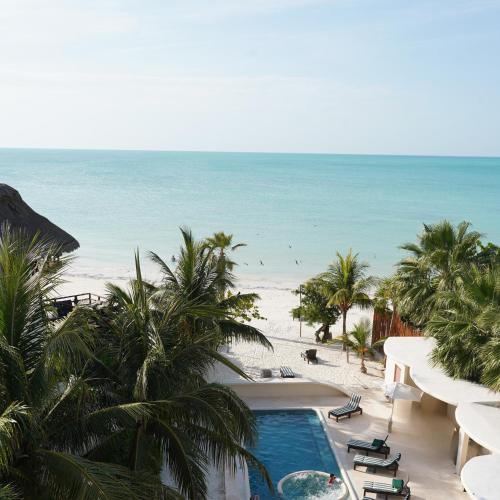 a view of the beach from the balcony of a resort at Beachfront Hotel Boutique DK in Holbox Island