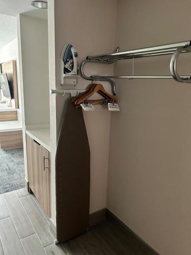 a room with a closet with a door and a shelf at Wingate by Wyndham Richmond Short Pump in Richmond