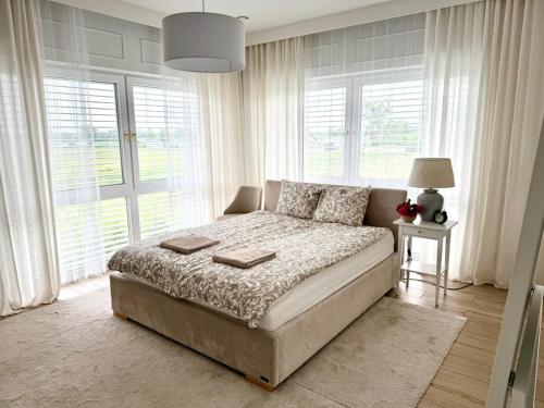 a bedroom with a bed and a large window at Villa Mare in Gdańsk