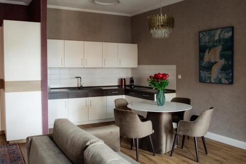 a kitchen with a table with a vase of flowers on it at Ferienwohnung Alte Münze mit Parkplatz in Zwickau