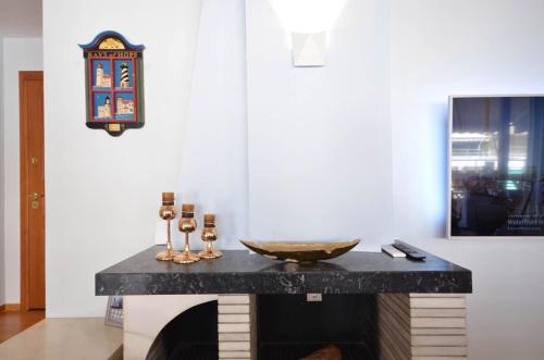 a marble counter with a bowl on it in a room at Piraeus Pasalimani LargeTerrace Seaview Apartment in Piraeus