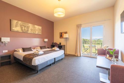 a bedroom with a large bed and a balcony at Mercure Aix-En-Provence Sainte-Victoire in Châteauneuf-le-Rouge