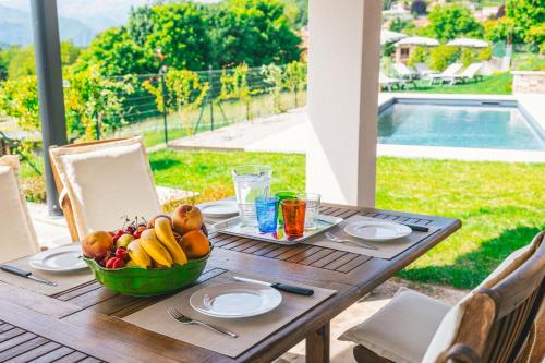 a wooden table with a bowl of fruit on it at La Tizzana in Armeno