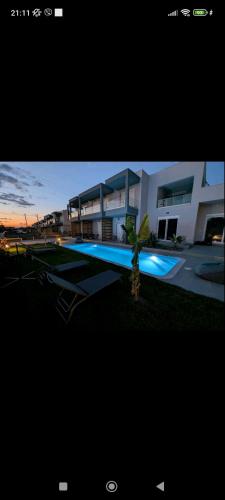 a view of a building with a swimming pool at 9 keys in Skala Rachoniou