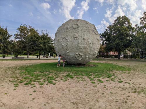 a person standing next to a large rock in a park at Harzschlösschen in Harzgerode