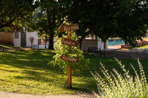 a sign in a park with two street signs at Mercure Aix-En-Provence Sainte-Victoire in Châteauneuf-le-Rouge