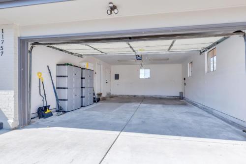 an empty garage with a garage door open at Vacation Launch Pad - Great for Groups in Arvada