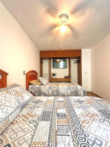 a bedroom with two beds and a ceiling at Cozy house in central location in Hércules